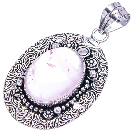 Oval rose quartz pendant with ornate silver-toned border and teardrop bail