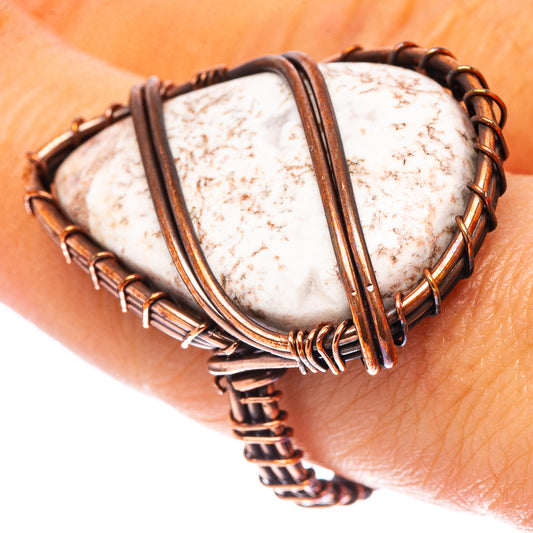 Oval white-and-brown speckled jasper ring in oxidized copper wire frame
