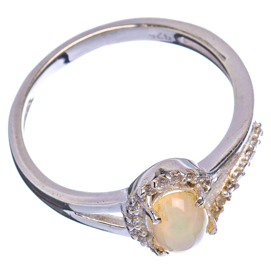 Sterling silver ring with oval opal-like center stone and cubic zirconia side accents