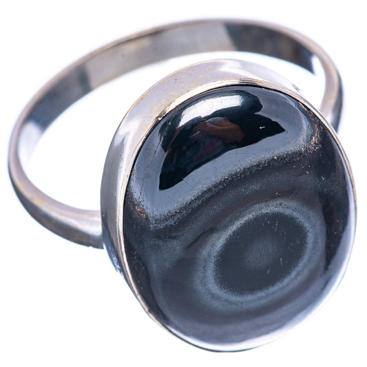 Sterling silver ring with oval dark psilomelane cabochon, angled view of band