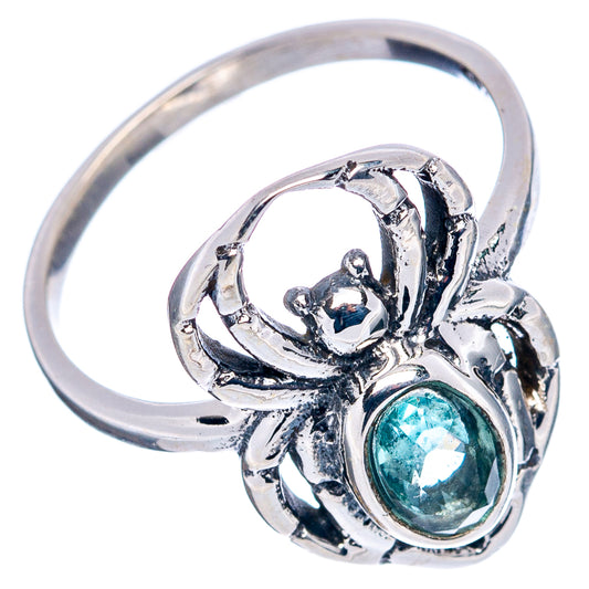 Sterling silver spider dainty ring with raised oval blue topaz stone and ornate web shank