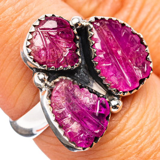 Sterling silver ring with three carved purple-red ruby gemstones, split prong setting