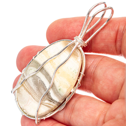 Banded agate wire wrap pendant, silver-plated oval with loop and banded stone stripes