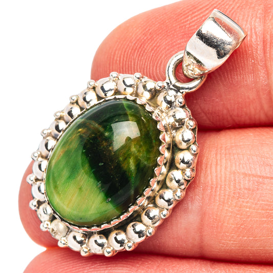 Sterling silver green cat's eye pendant with ornate bezel and bail, oval stone