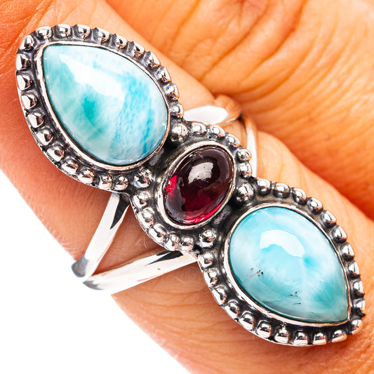 Sterling silver ring with turquoise teardrop larimar stones and dark red garnet center