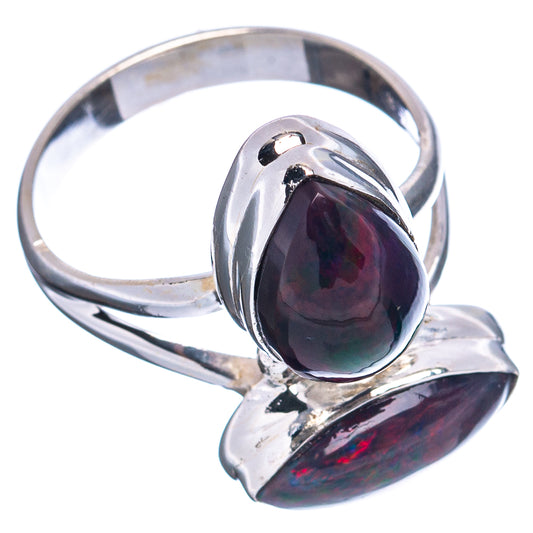 Sterling silver opal ring with dark oval bezel-set stone and second opal drop