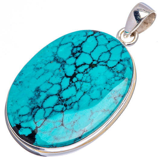 Oval turquoise pendant on .925 sterling silver frame with loop bail; black veining detail.