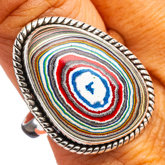 Oval sterling silver ring with colorful striped fordite inlay and rope-edge bezel