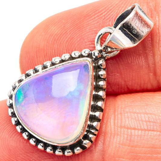 Sterling silver opal pendant with teardrop bezel, pink-lavender and rainbow iridescence.