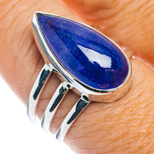 Sterling silver tanzanite ring with oval blue gemstone on finger, side view