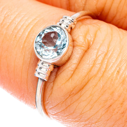 Dainty sterling silver ring with round blue topaz and textured band