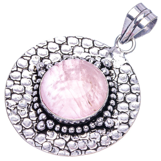 German silver circular rose quartz pendant, pink cabochon center, textured border, bail loop