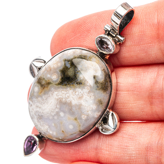 Oval ocean jasper pendant with sterling silver bezel and amethyst drops
