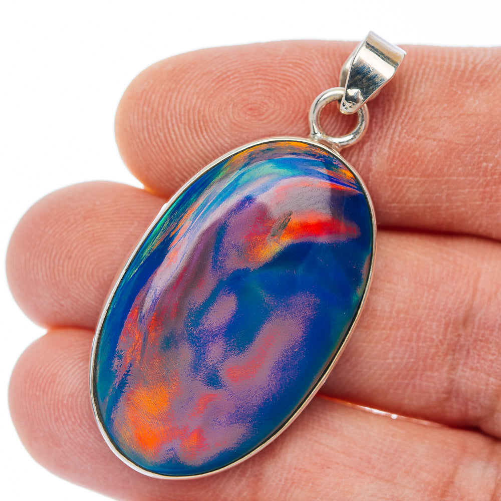 Oval opal pendant with silver bail, blue with orange-red swirls