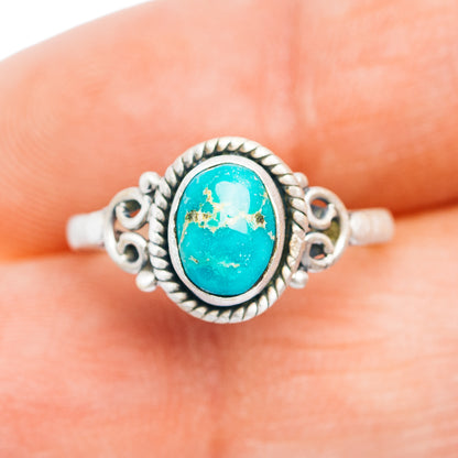 Turquoise oval sterling silver ring with decorative scrollwork and raised bezel