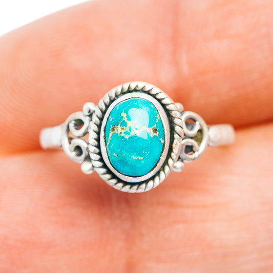 Turquoise oval sterling silver ring with decorative scrollwork and raised bezel