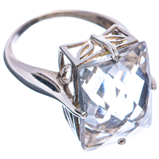 Sterling silver ring showing large square clear stone and curved band with side cutouts