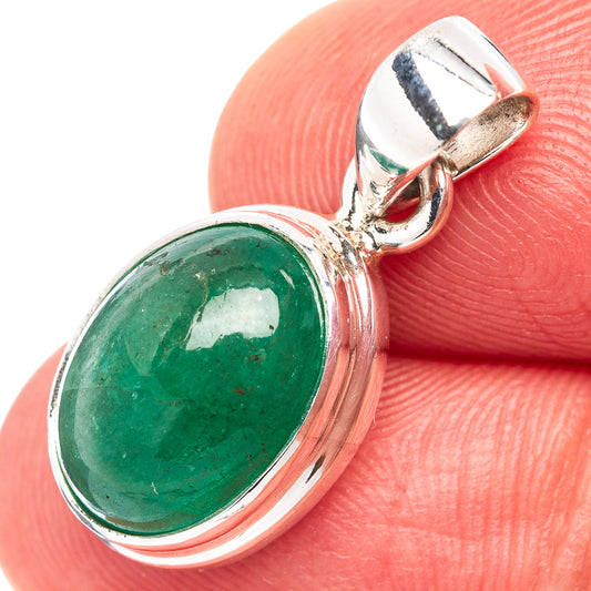 Close-up of oval green emerald set in .925 sterling silver bezel with bail