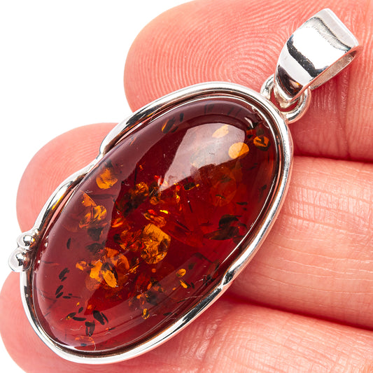 Oval Baltic amber pendant with .925 sterling silver bezel and bail, polished frame