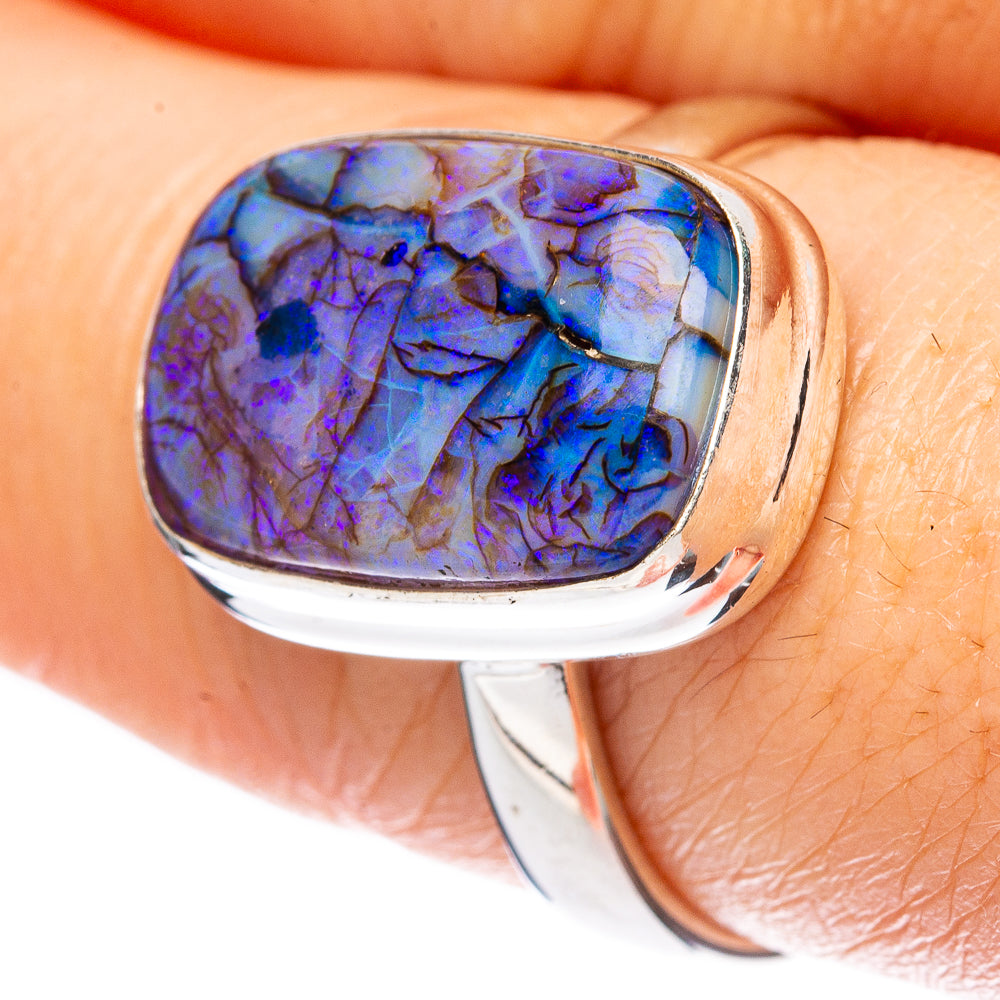 Sterling silver opal ring with oval blue-purple cabochon and polished split shank