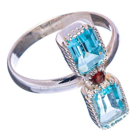Sterling silver bow-style ring with two blue topaz-like stones and red center