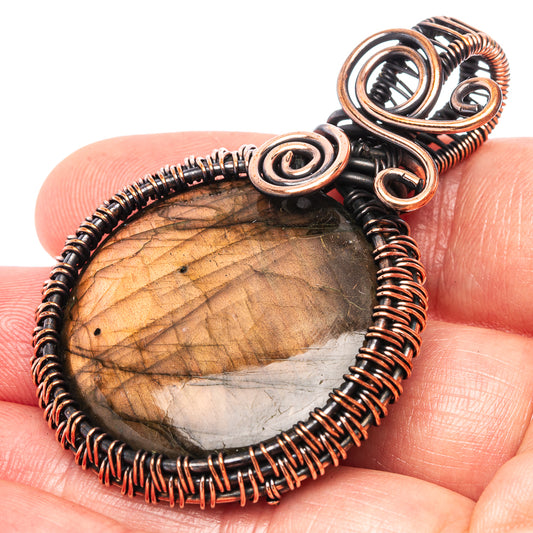 Oxidized copper wire-wrapped labradorite oval pendant with spiral frame