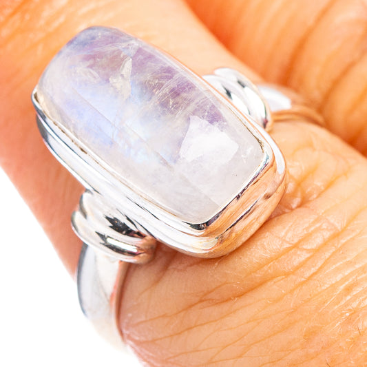 Sterling silver moonstone ring close-up with iridescent oval white stone and band details