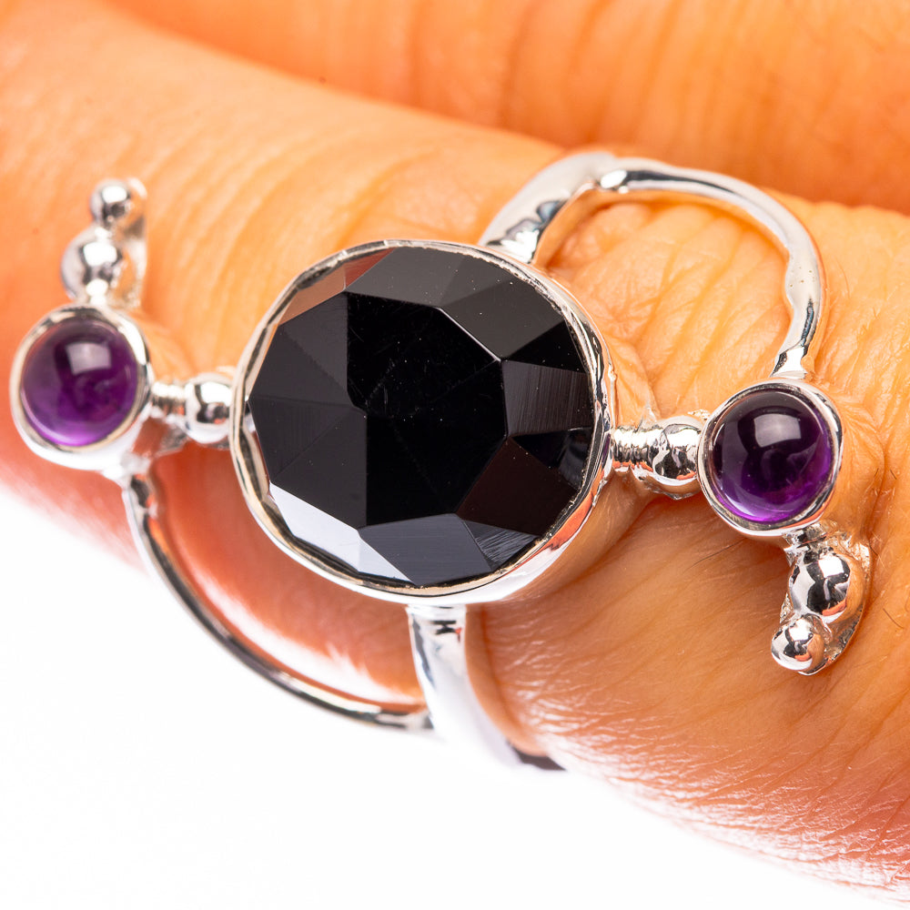 Sterling silver ring with round amethyst side stones and faceted black onyx oval