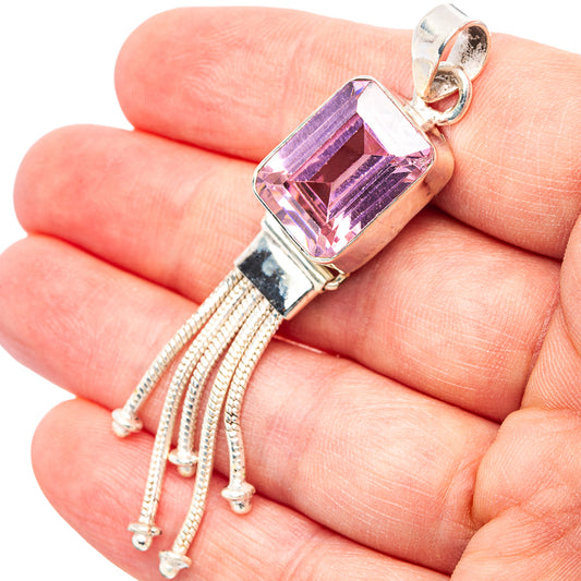 Close-up sterling silver pink quartz pendant with step-cut rectangular stone and tassel chain