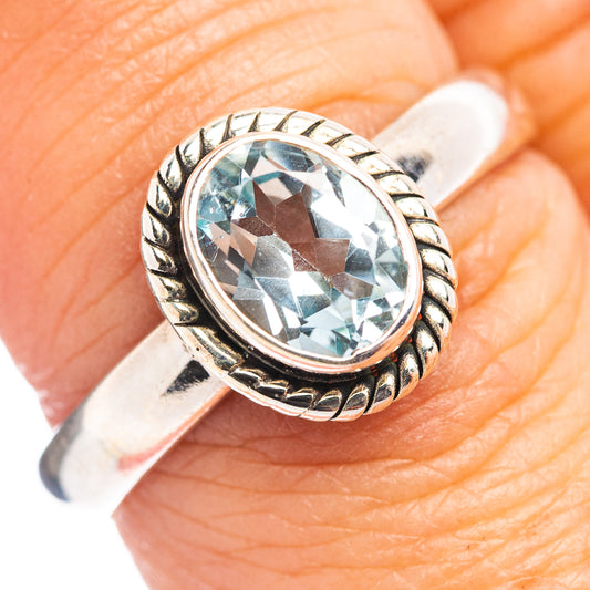 Sterling silver oval blue topaz ring with braided bezel and ornate side detail