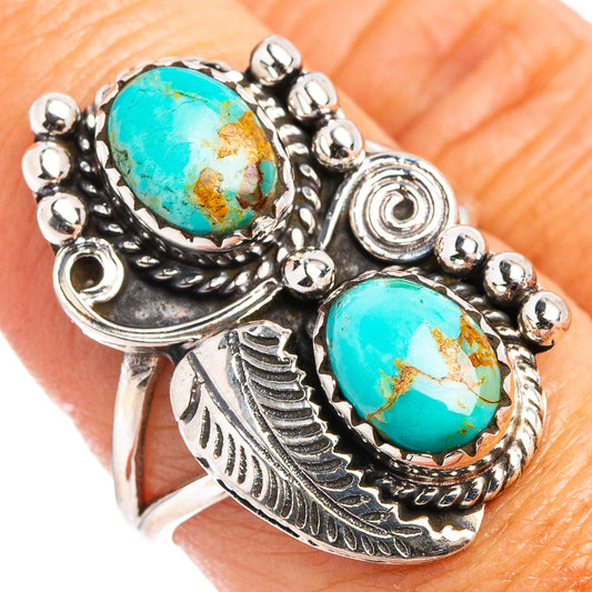 Turquoise oval silver ring with two bezel-set stones and leaf-like engraved details