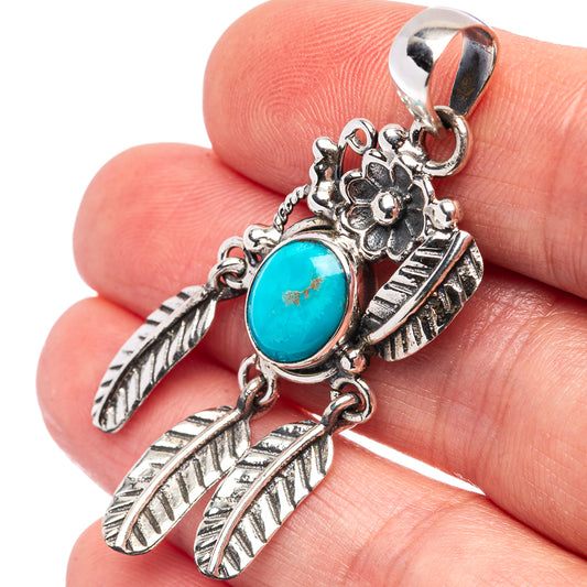 Sterling silver turquoise oval pendant with etched feather charms and flower detail