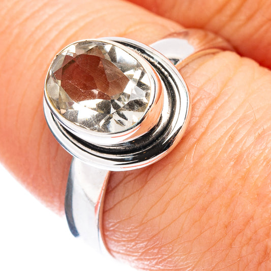Sterling silver ring with faceted light gemstone in round bezel, close-up