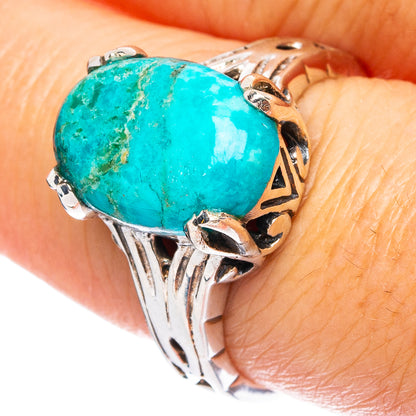 Sterling silver ring with large oval turquoise cabochon and detailed filigree setting