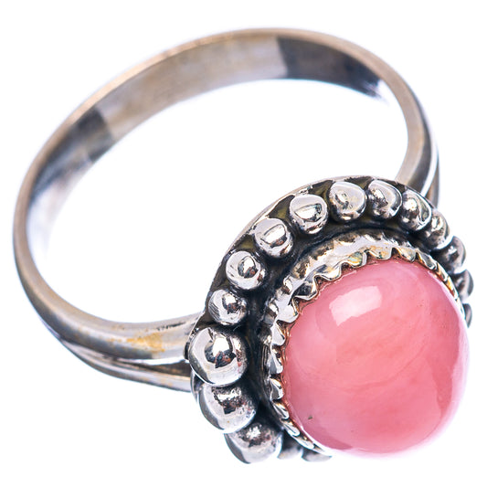 Sterling silver opal ring with pink round cabochon and raised beaded edge, side view