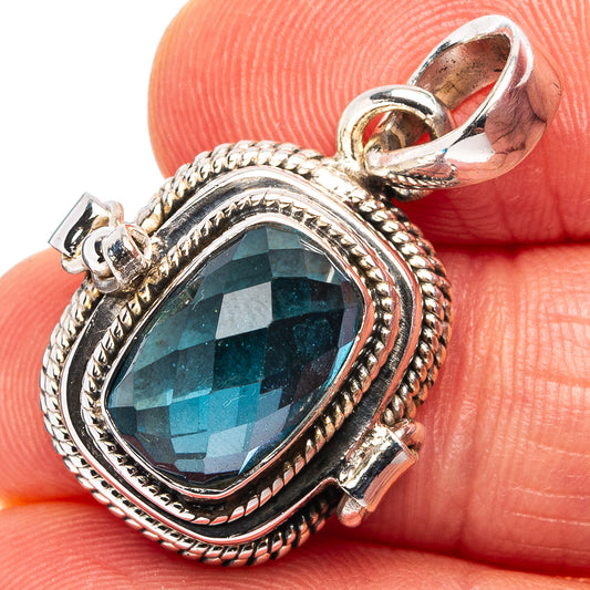 Sterling silver pendant with blue oval gemstone and rope-braid bezel, close-up
