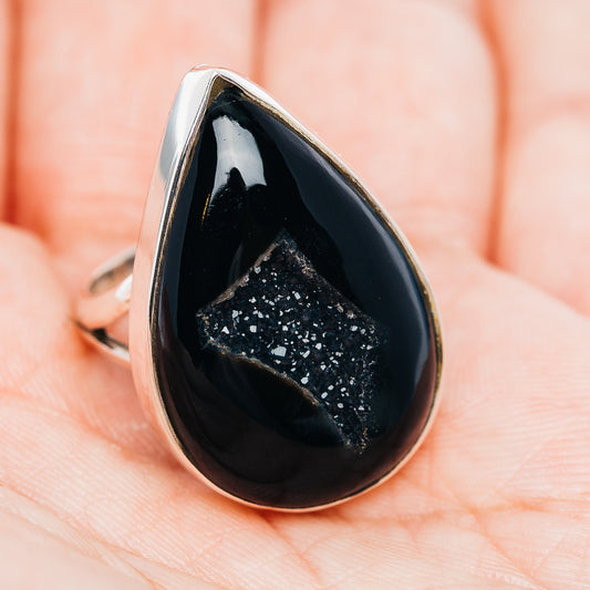 Teardrop black druzy agate ring in silver-tone setting, side view