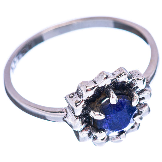Sterling silver ring with round blue gemstone and ornate prong setting on band
