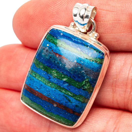 Sterling silver pendant with blue-green striped oval gemstone, framed in square bezel