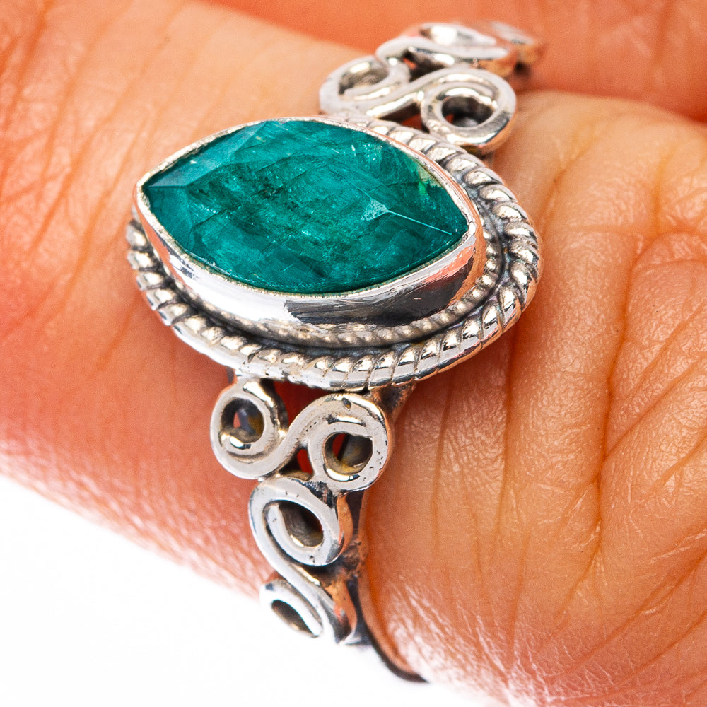 Sterling silver emerald-green teardrop ring with ornate scalloped bezel, on finger