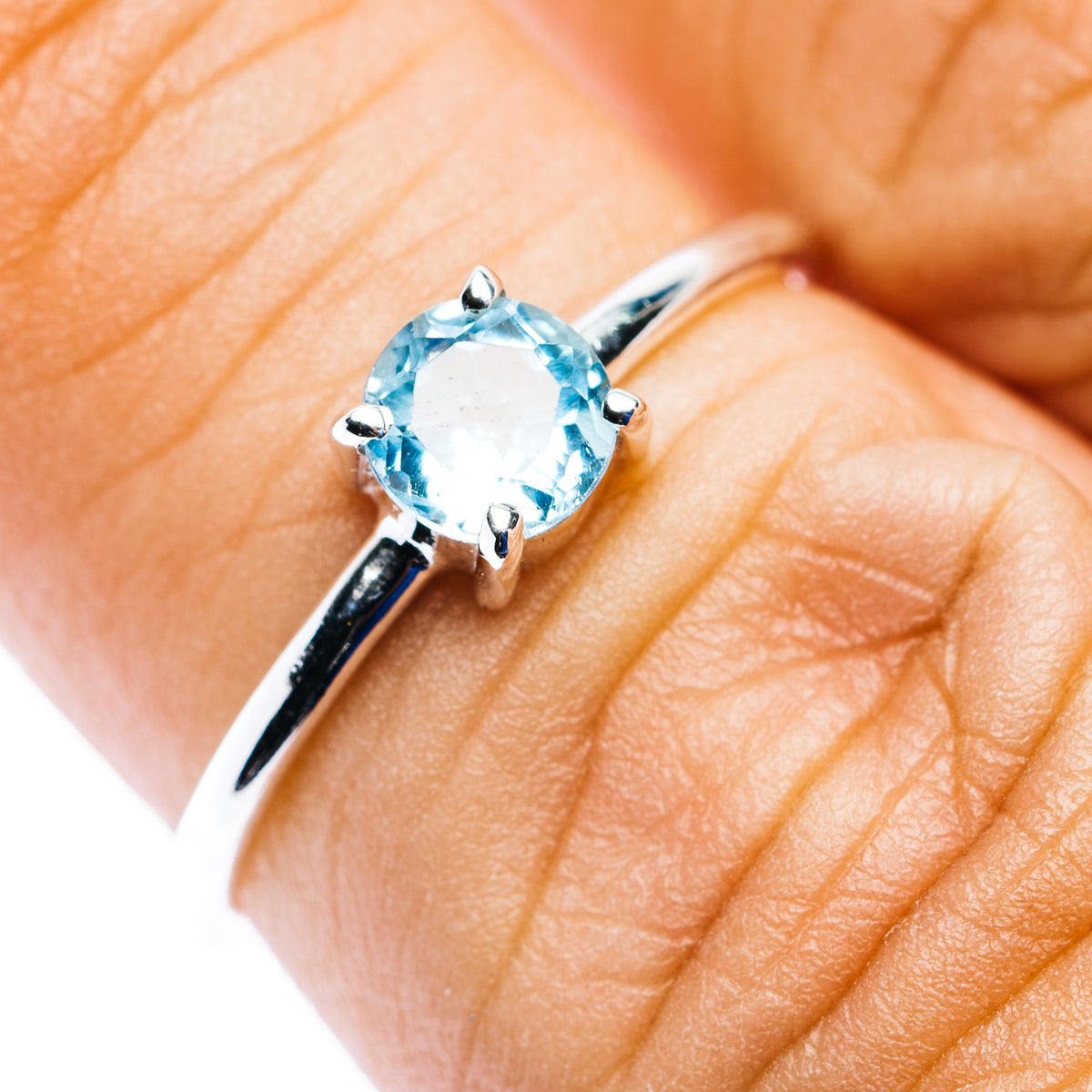 Sterling silver stackable ring with round blue topaz center stone