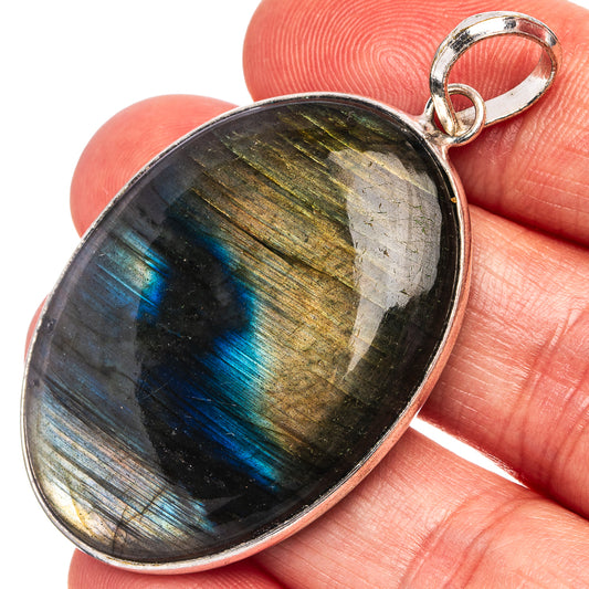 Oval labradorite cabochon pendant, silver-plated bezel and loop bail with blue flash