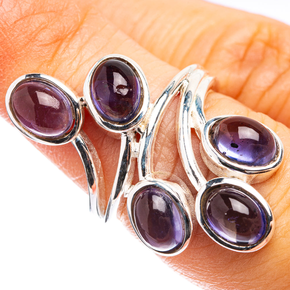 Sterling silver ring with five oval purple-blue gemstones on a wave setting