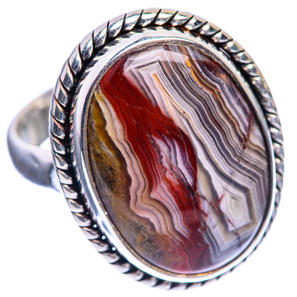 Oval crazy lace agate ring, angled view, red and gray striped stone in twisted silver setting