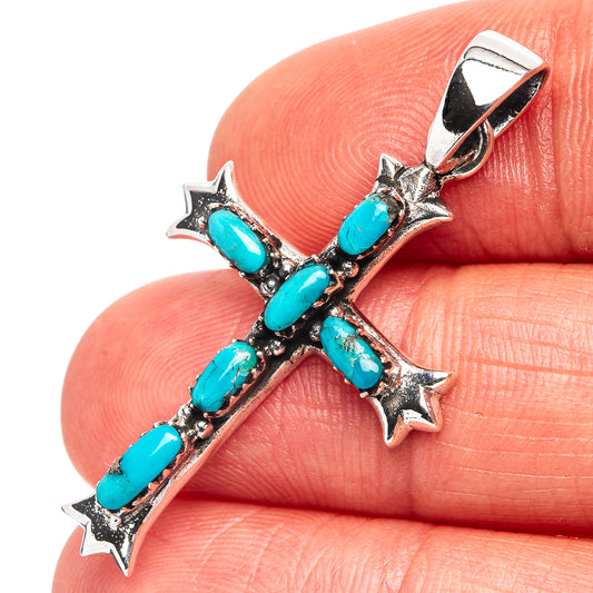 Turquoise cross pendant in .925 sterling silver with blue stone inlays and star accents.