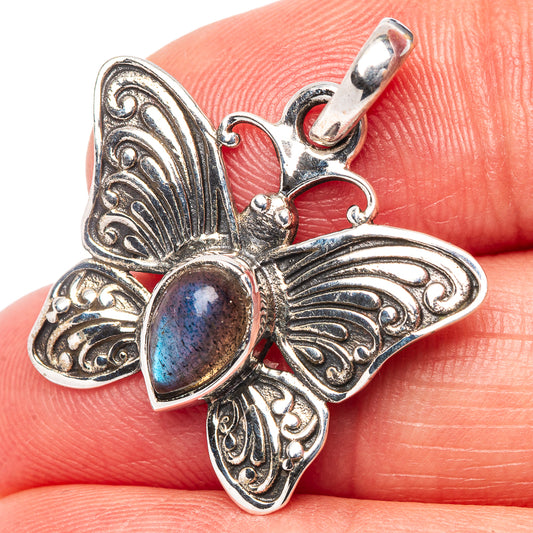 Close-up sterling silver butterfly pendant with blue labradorite oval gemstone and loop bail