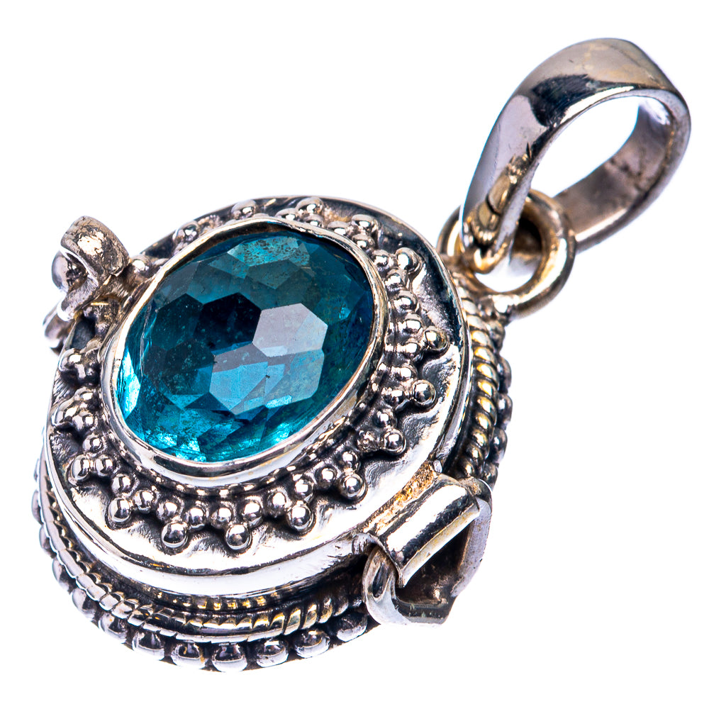 Sterling silver oval gemstone pendant with faceted teal-blue center and detailed frame