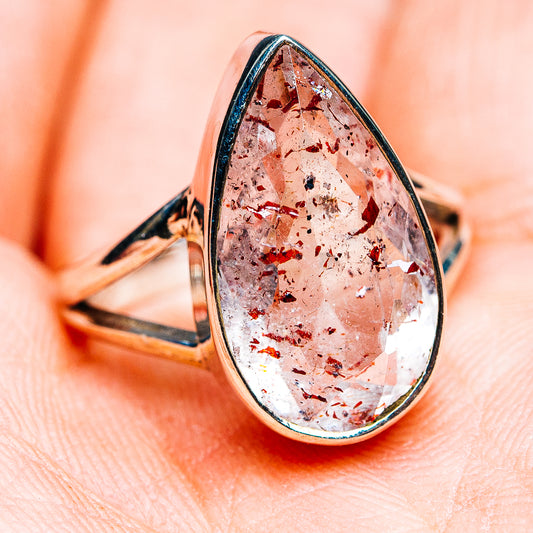 Sterling silver teardrop lepidocrocite ring with faceted red-pink stone, open prongs