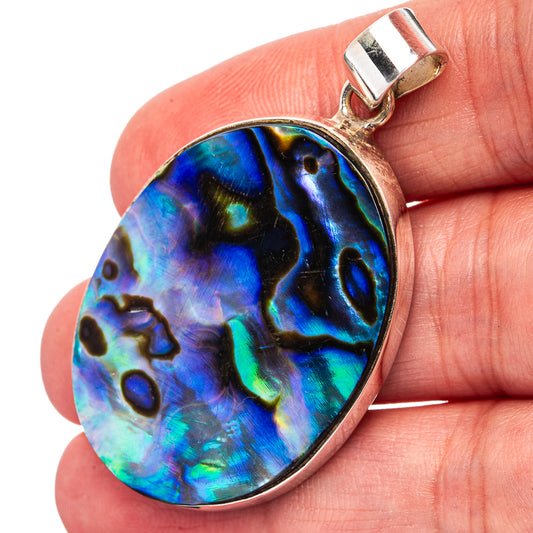 Iridescent abalone shell pendant in teardrop shape with sterling silver bail