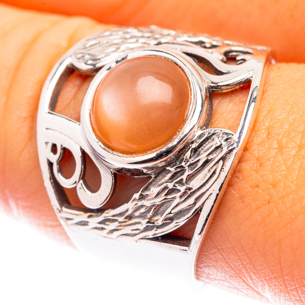Sterling silver moonstone ring with oval peach cabochon and engraved patterned band
